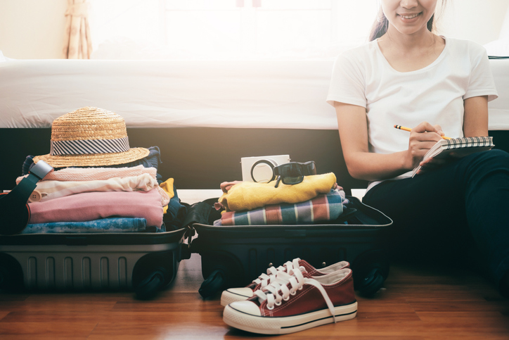 young woman with a checklist for her wellness vacation